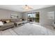 Living room with comfortable seating, sliding door to balcony, and water view at 6321 Newtown Cir # 21B4, Tampa, FL 33615