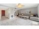 Living area featuring a sectional sofa, coffee table, area rug, and unique ceiling fan at 6321 Newtown Cir # 21B4, Tampa, FL 33615