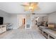 Open living room with fireplace, ceiling fan, and area rug at 6321 Newtown Cir # 21B4, Tampa, FL 33615
