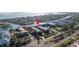 Aerial view of a waterfront community with docks, a tennis court, and lush landscaping at 637 Pinellas Bayway S # 111, St Petersburg, FL 33715