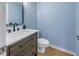 Modern half-bath with dark wood vanity, white countertop, and black fixtures at 637 Pinellas Bayway S # 111, St Petersburg, FL 33715