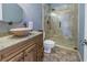 Bathroom with tiled shower, vessel sink, and granite countertop at 637 Pinellas Bayway S # 111, St Petersburg, FL 33715