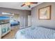 Bedroom with mirrored closet doors, ceiling fan, and wood-look flooring at 637 Pinellas Bayway S # 111, St Petersburg, FL 33715