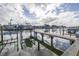 Boat lift and dock with waterfront property in the background at 637 Pinellas Bayway S # 111, St Petersburg, FL 33715