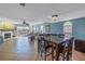 Dining area in living room with a table, chairs, and water views through sliding glass doors at 637 Pinellas Bayway S # 111, St Petersburg, FL 33715