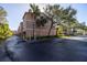 View of the building exterior with a paved parking area in front at 637 Pinellas Bayway S # 111, St Petersburg, FL 33715