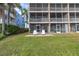 Exterior view of the waterfront property with lawn and seating area at 637 Pinellas Bayway S # 111, St Petersburg, FL 33715