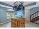 Kitchen with island, hanging pot rack, and blue walls at 637 Pinellas Bayway S # 111, St Petersburg, FL 33715