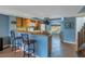 Kitchen with oak cabinets, white appliances, breakfast bar, and tiled floor at 637 Pinellas Bayway S # 111, St Petersburg, FL 33715