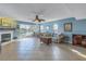 Living room with fireplace, tile floor, sliding glass doors to balcony, and water views at 637 Pinellas Bayway S # 111, St Petersburg, FL 33715