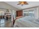 Main bedroom with mirrored closet doors, wooden furniture, and sliding door to balcony at 637 Pinellas Bayway S # 111, St Petersburg, FL 33715