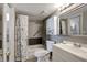 Clean bathroom with white vanity, shower/tub combo, and floral curtain at 6923 Stonesthrow N Cir # 4105, St Petersburg, FL 33710