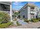 Inviting condo exterior with lush landscaping and a paved walkway at 6923 Stonesthrow N Cir # 4105, St Petersburg, FL 33710