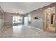 Living/dining room with tile floors, sliding door to the patio, and access to the bathroom at 6923 Stonesthrow N Cir # 4105, St Petersburg, FL 33710
