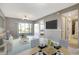 Living room with dining area, view of the patio and waterfront, and access to the bathroom at 6923 Stonesthrow N Cir # 4105, St Petersburg, FL 33710
