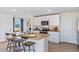 Modern kitchen with white cabinets, granite island, and stainless steel appliances at 7123 Broad River Ave, Land O Lakes, FL 34638