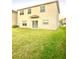 Well-maintained backyard with lush grass and a view of the home at 7423 Pulteney Dr, Zephyrhills, FL 33545
