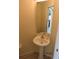 Updated half bathroom with pedestal sink and modern fixtures at 7423 Pulteney Dr, Zephyrhills, FL 33545
