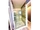 This renovated bathroom features a glass-enclosed shower with updated tile and fixtures at 7423 Pulteney Dr, Zephyrhills, FL 33545