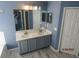 Double vanity bathroom with gray cabinets and white countertop at 7423 Pulteney Dr, Zephyrhills, FL 33545