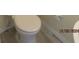 Clean and simple bathroom with a pedestal sink and toilet at 7423 Pulteney Dr, Zephyrhills, FL 33545