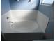 Clean bathroom with white bathtub and blue walls at 7423 Pulteney Dr, Zephyrhills, FL 33545