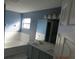 Double vanity bathroom with gray cabinets and white countertop at 7423 Pulteney Dr, Zephyrhills, FL 33545