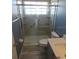 Bathroom showcasing a tiled shower with glass door, towel bar, and a sink with gray cabinets at 7423 Pulteney Dr, Zephyrhills, FL 33545