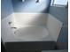 Clean white tiled bathtub with classic trim details, and a simple faucet design at 7423 Pulteney Dr, Zephyrhills, FL 33545
