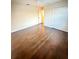 Spacious bedroom features wood floors, neutral walls, double door closet, and natural light at 7423 Pulteney Dr, Zephyrhills, FL 33545