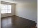 Spacious bedroom with dark brown wood flooring at 7423 Pulteney Dr, Zephyrhills, FL 33545