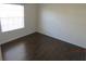 Bright bedroom with dark laminate flooring at 7423 Pulteney Dr, Zephyrhills, FL 33545