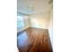 Bedroom featuring hardwood flooring, a ceiling fan, and ample natural light from a window at 7423 Pulteney Dr, Zephyrhills, FL 33545