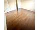Bedroom features hardwood floors, neutral walls, and a closet for convenient storage at 7423 Pulteney Dr, Zephyrhills, FL 33545