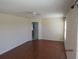 Bright bedroom featuring hardwood floors and an ensuite bathroom at 7423 Pulteney Dr, Zephyrhills, FL 33545