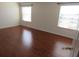 Spacious bedroom with hardwood floors and large windows at 7423 Pulteney Dr, Zephyrhills, FL 33545