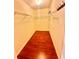 Spacious walk-in closet with hardwood floors, wire shelving, and ample storage space at 7423 Pulteney Dr, Zephyrhills, FL 33545