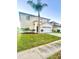 Charming two-story home with a well-manicured lawn and a beautiful palm tree at 7423 Pulteney Dr, Zephyrhills, FL 33545
