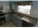 Kitchen boasts granite countertops and updated stainless steel appliances at 7423 Pulteney Dr, Zephyrhills, FL 33545