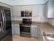 Modern kitchen with stainless steel appliances and granite countertops at 7423 Pulteney Dr, Zephyrhills, FL 33545