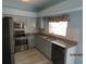 Bright kitchen with light cabinets, granite counters, and stainless steel appliances at 7423 Pulteney Dr, Zephyrhills, FL 33545