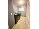 Laundry room featuring new front load washer and dryer, light gray walls and tiled floor at 7423 Pulteney Dr, Zephyrhills, FL 33545