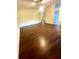 Open concept living room with hardwood floors, ceiling fan, and view of the front entry at 7423 Pulteney Dr, Zephyrhills, FL 33545