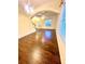 Spacious living room with wood floors, ceiling fan, and large windows for ample natural light at 7423 Pulteney Dr, Zephyrhills, FL 33545