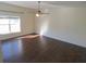 Spacious living room with hardwood floors and ceiling fan at 7423 Pulteney Dr, Zephyrhills, FL 33545