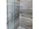 Updated shower with gray tile and glass door at 7423 Pulteney Dr, Zephyrhills, FL 33545