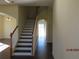Elegant staircase with dark wood steps and white risers at 7423 Pulteney Dr, Zephyrhills, FL 33545