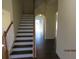 Interior staircase showcasing wooden handrails and dark wood flooring at 7423 Pulteney Dr, Zephyrhills, FL 33545