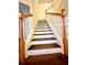 Classic wooden staircase with white risers and stained wood railings, blending style and functionality at 7423 Pulteney Dr, Zephyrhills, FL 33545