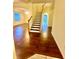 Interior shot of staircase with wood flooring, wooden railing and natural light at 7423 Pulteney Dr, Zephyrhills, FL 33545